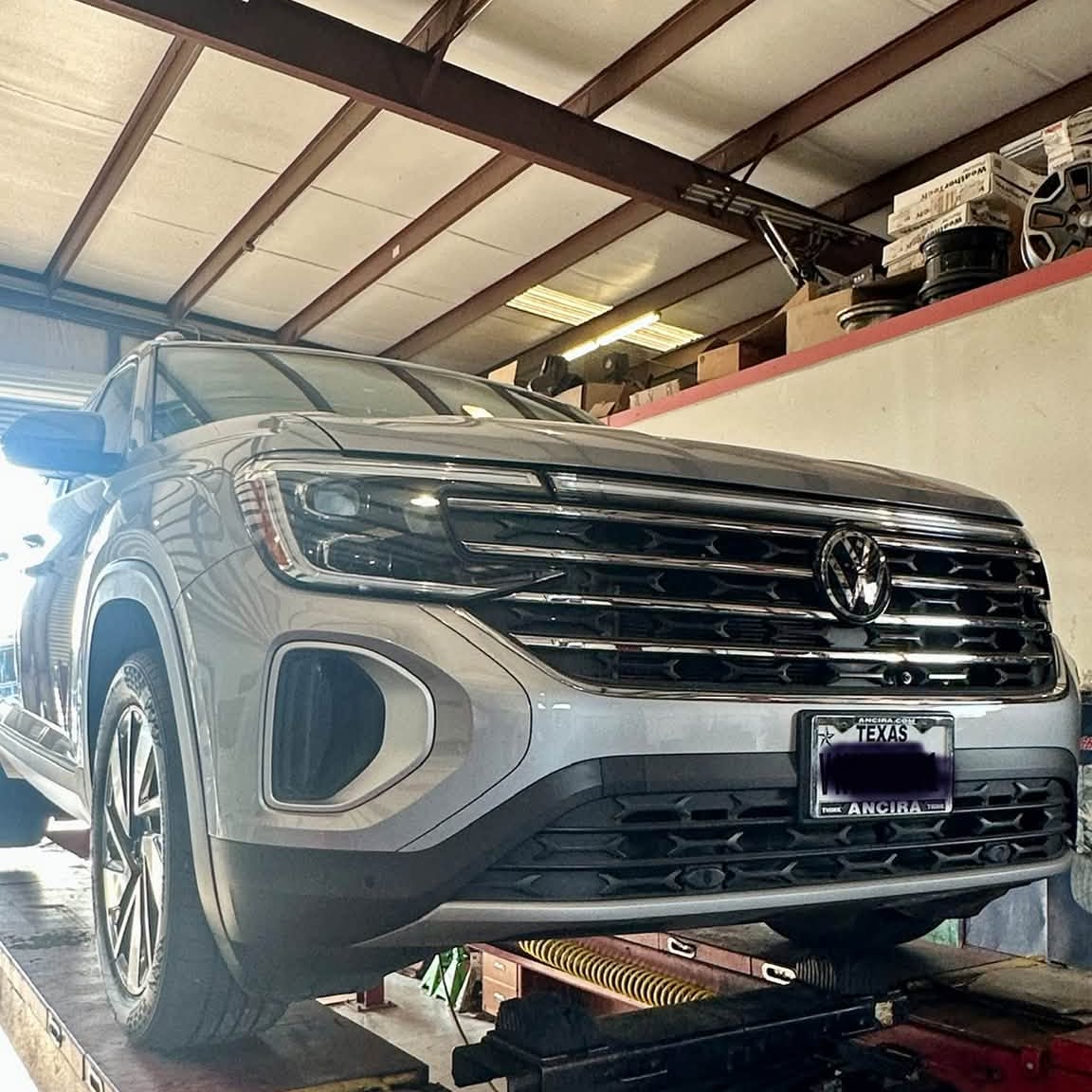 A vehicle up on the lift at South Texas Auto Rebuilders